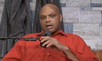 Charles Barkley holds a mic on his podcast.