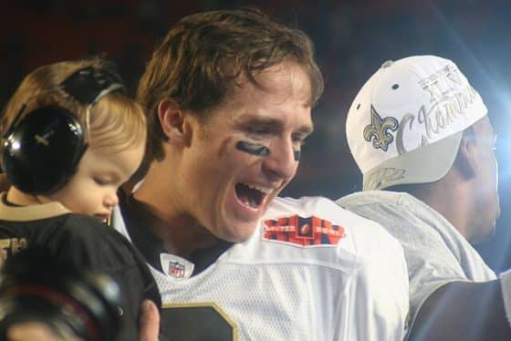 Drew Brees holds his son after the Super Bowl.