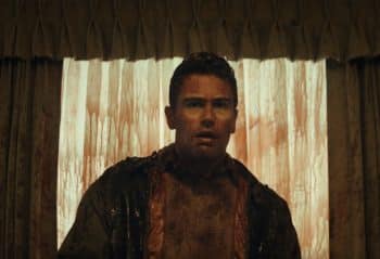 A bloody Theo James looks and stares.