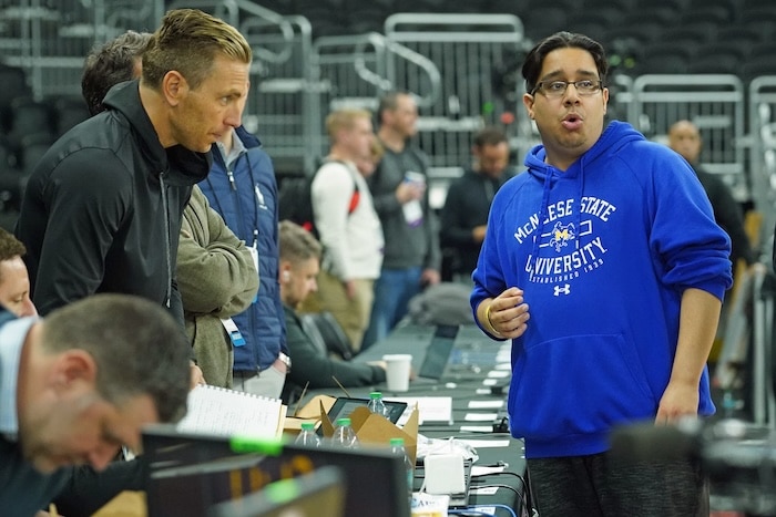 Amir Khan, McNeese State men's basketball manager stands and looks.