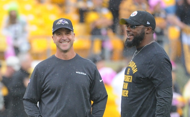 Baltimore Ravens head coach John Harbaugh talks with Pittsburgh Steelers.