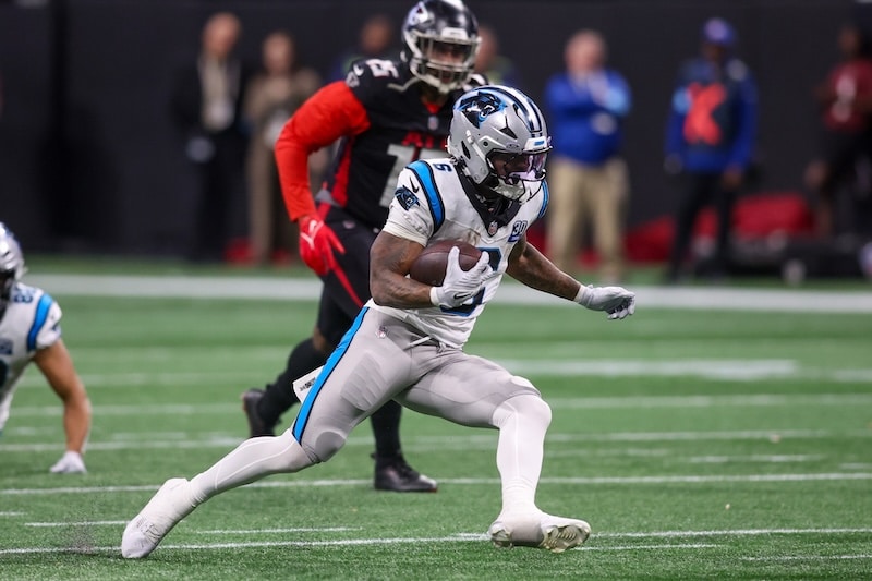 Carolina Panthers running back Miles Sanders runs the ball.