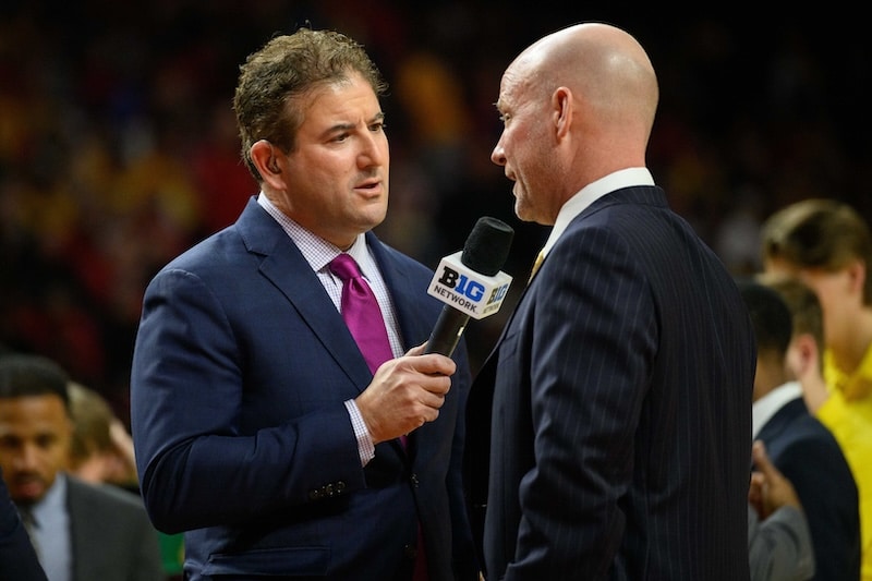 Andy Katz holds a microphone.