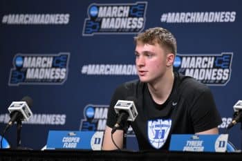 Cooper Flagg sits at the podium.