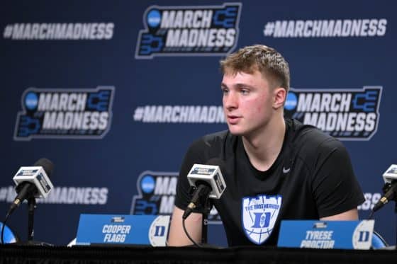Cooper Flagg sits at the podium.