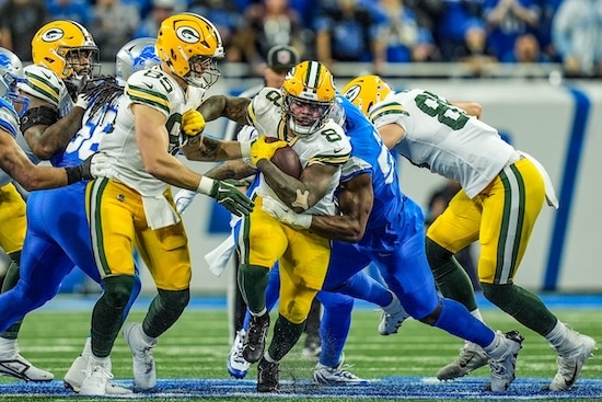 Green Bay Packers running back Josh Jacobs breaks through the Detroit Lions.