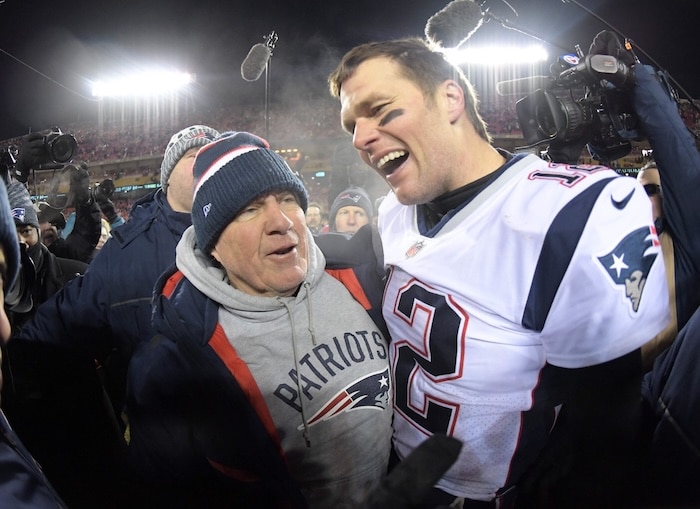 New England Patriots quarterback Tom Brady stands with Bill Belichick.
