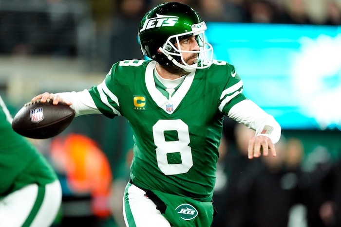 Aaron Rodgers holds the ball and readies to throw.