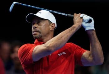 Tiger Woods holds a golf club.