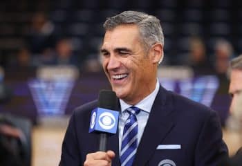 Jay Wright holds a mic up.
