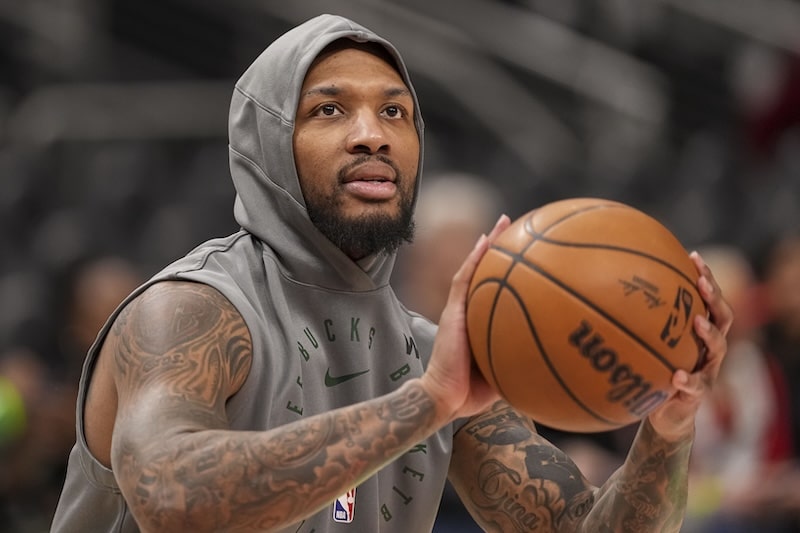 Damian Lillard holds the ball and goes to shoot.