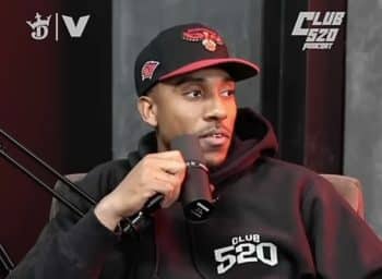 Jeff Teague holds a mic and stares.
