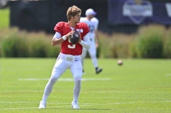 J.J. McCarthy holds the ball and prepares to throw.
