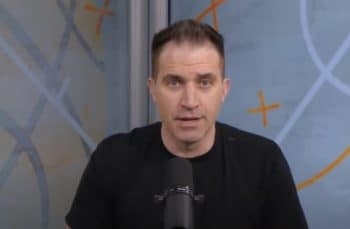 Jon Rothstein sits in front of a mic.