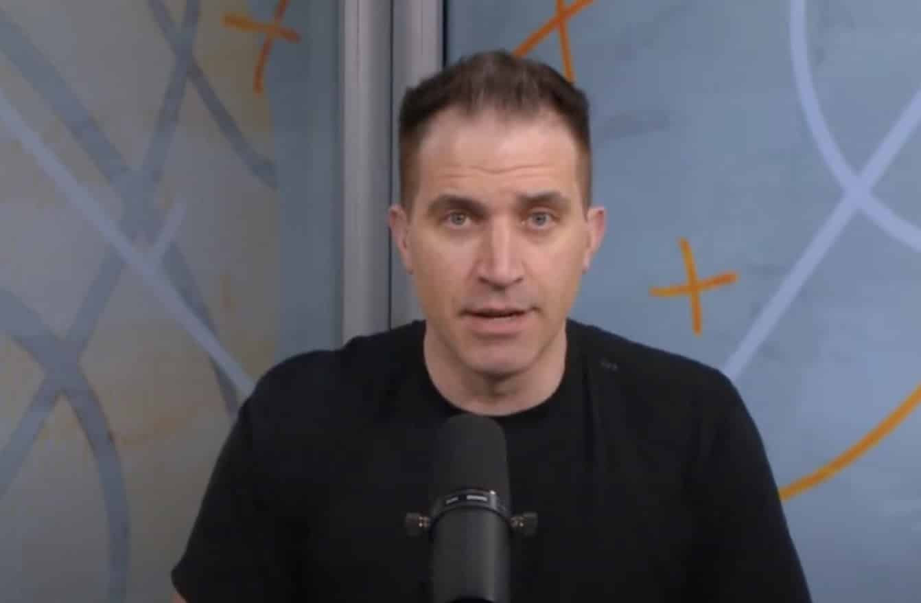 Jon Rothstein sits in front of a mic.