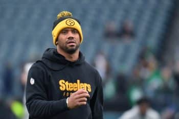 Russell Wilson talks on the field.