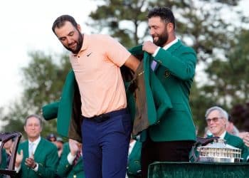 2023 Masters champion Jon Rahm places the green jacket on 2024 Masters champion Scottie Scheffler.
