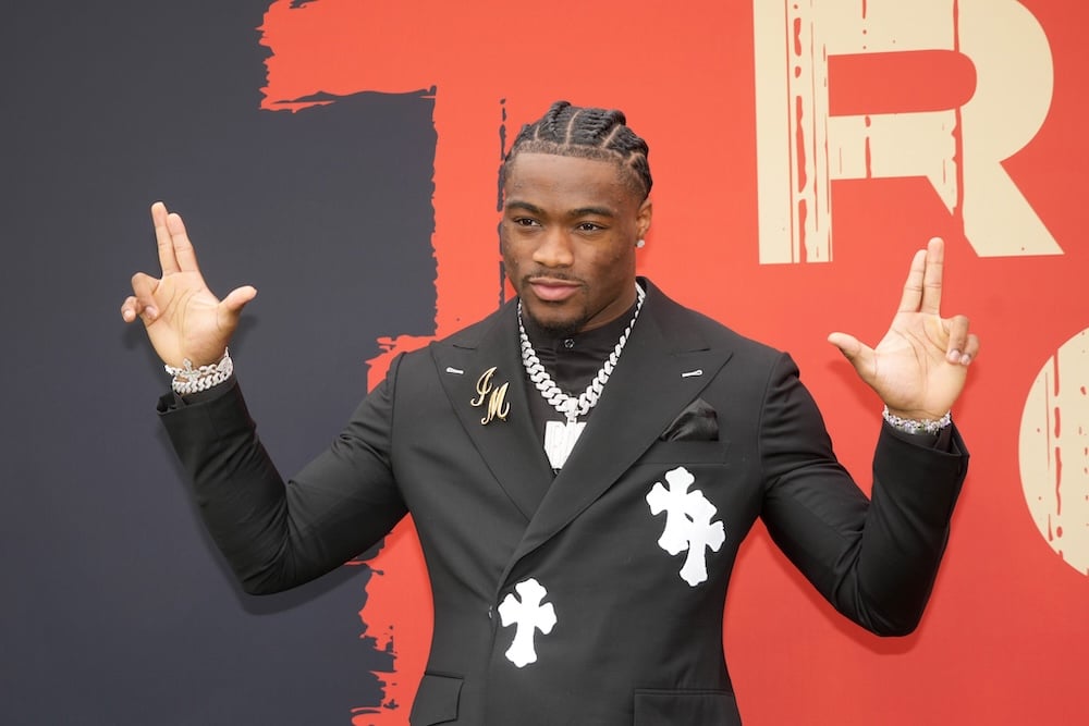 Alabama Crimson Tide quarterback Jalen Milroe puts his hands up.