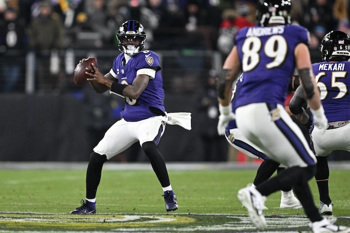 Lamar Jackson reaches back to pass.