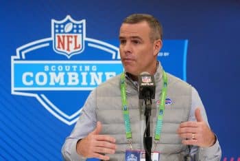 Buffalo Bills general manager Brandon Beane holds hand up at podium.