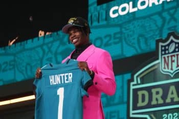Colorado Buffaloes wide receiver Travis Hunter holds up a jersey.