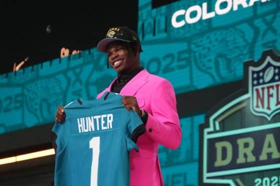 Colorado Buffaloes wide receiver Travis Hunter holds up a jersey.