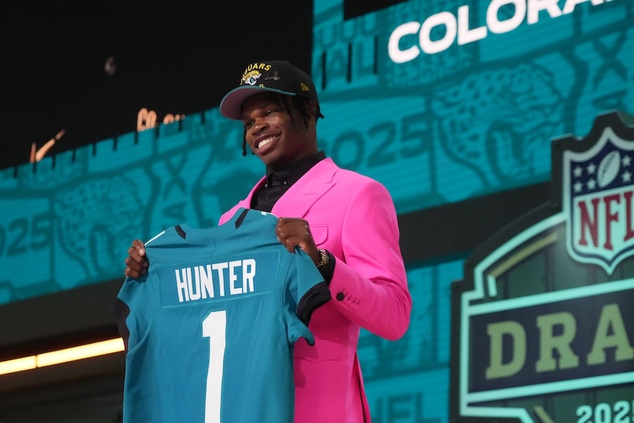 Colorado Buffaloes wide receiver Travis Hunter holds up a jersey.
