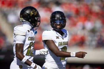 Colorado Buffalos quarterback Shedeur Sanders walk on field.