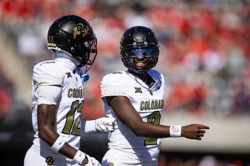 Colorado Buffalos quarterback Shedeur Sanders walk on field.