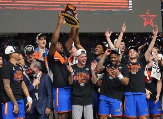Florida Gators players hoist the trophy after defeating the Houston Cougars.