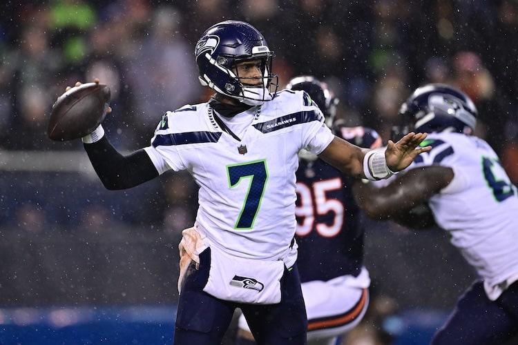 Seattle Seahawks quarterback Geno Smith readies to throw a ball.