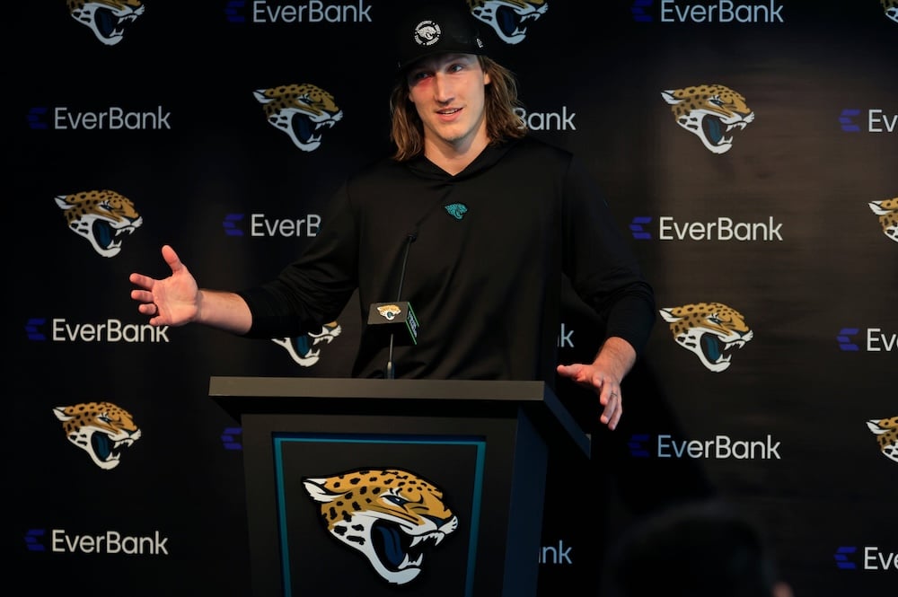 Jacksonville Jaguars quarterback Trevor Lawrence stands at a podium.