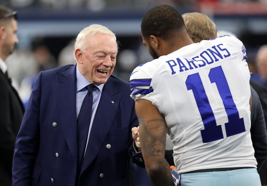 Jerry Jones and Micah Parsons shake hands.