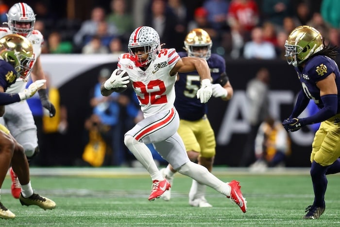 Ohio State Buckeyes running back TreVeyon Henderson runs the ball.