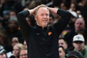 Phoenix Suns head coach Mike Budenholzer puts his hands over his head.