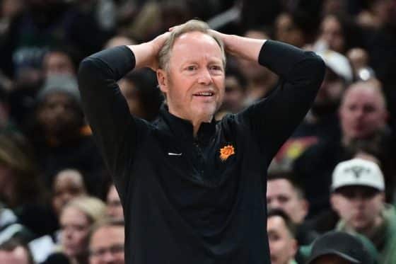 Phoenix Suns head coach Mike Budenholzer puts his hands over his head.