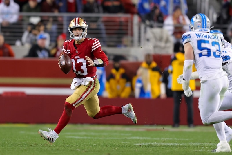 San Francisco 49ers quarterback Brock Purdy runs with ball.