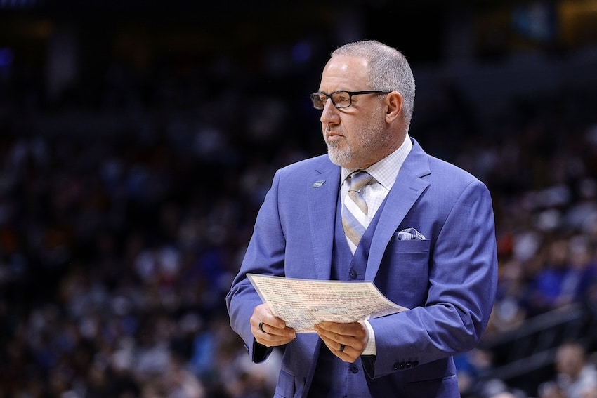 Texas A&M Aggies head coach Buzz Williams holds papers.