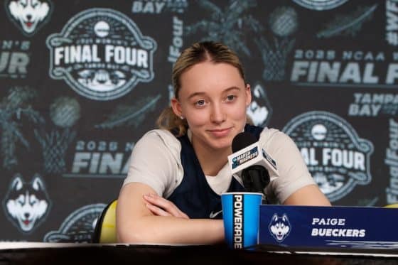 UConn Huskies guard Paige Bueckers sits at a desk.
