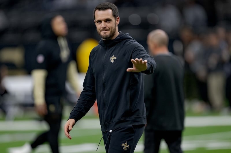 New Orleans Saints quarterback Derek Carr waves hi.