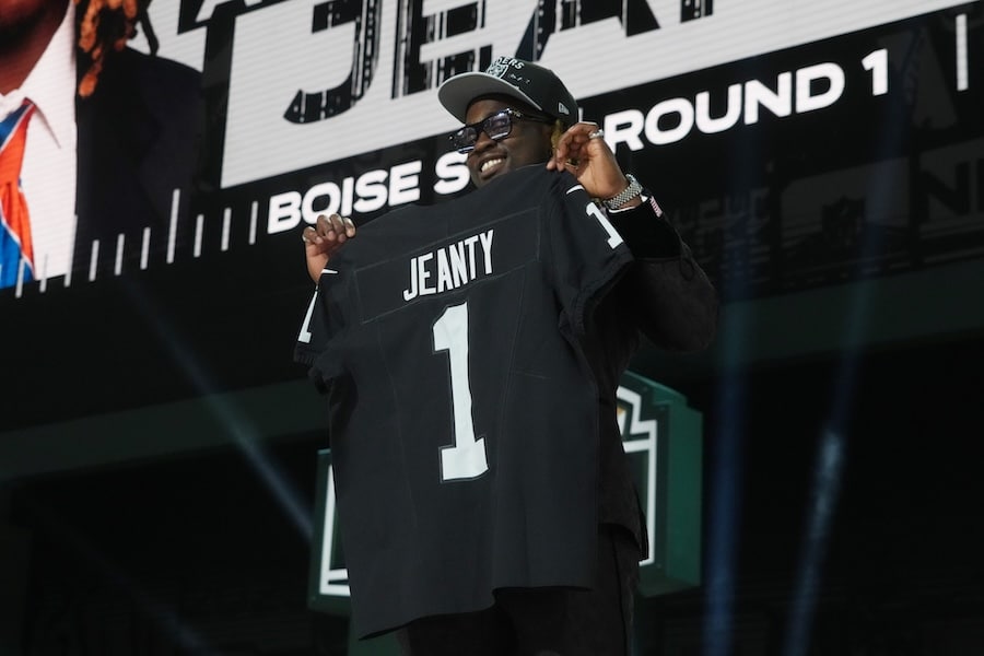 Boise State Broncos running back Ashton Jeanty holds his jersey up.