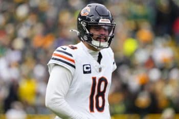 Chicago Bears quarterback Caleb Williams stands up on field.