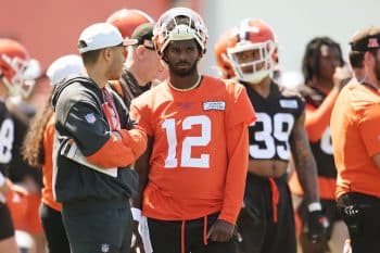 Cleveland Browns quarterback Shedeur Sanders stands in the huddle.
