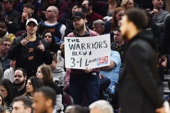 NBA fan holds a 3-1 sign.