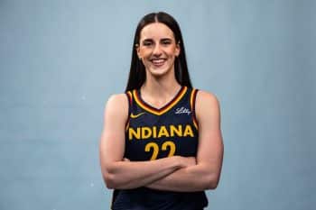 Indiana Fever guard Caitlin Clark has her arms crossed.