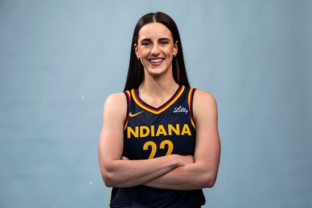 Indiana Fever guard Caitlin Clark has her arms crossed.