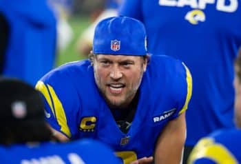 Los Angeles Rams quarterback Matthew Stafford sits on a knee.