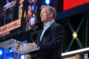 NFL commissioner Roger Goodell stands at a mic.