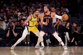 Jalen Brunson dribbles the ball with Tyrese Haliburton on him.