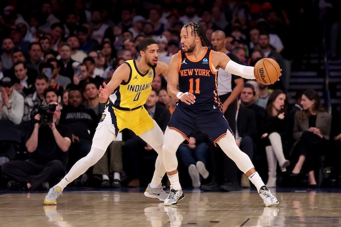Jalen Brunson dribbles the ball with Tyrese Haliburton on him.